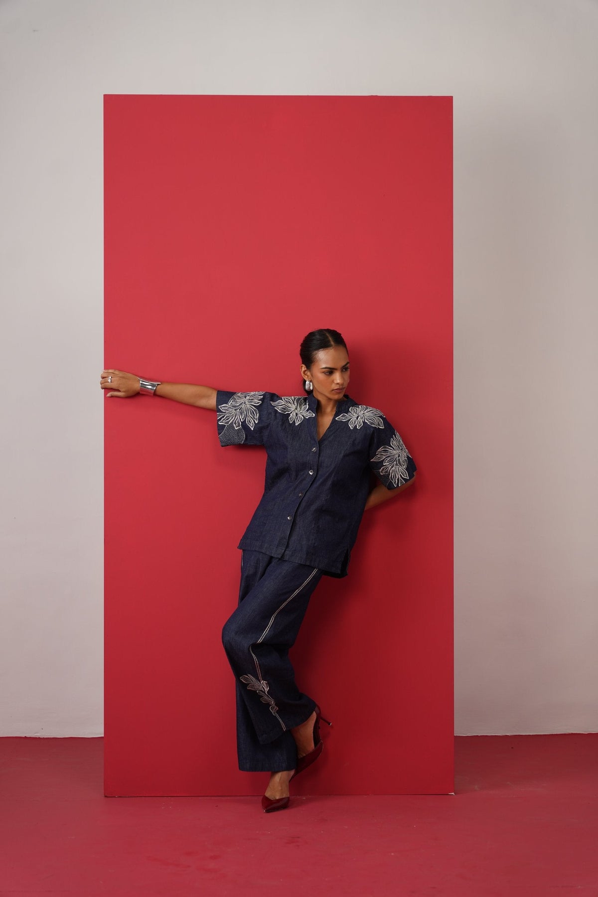 Darbar AW26: embroidered denim shirt, arm on a red panel